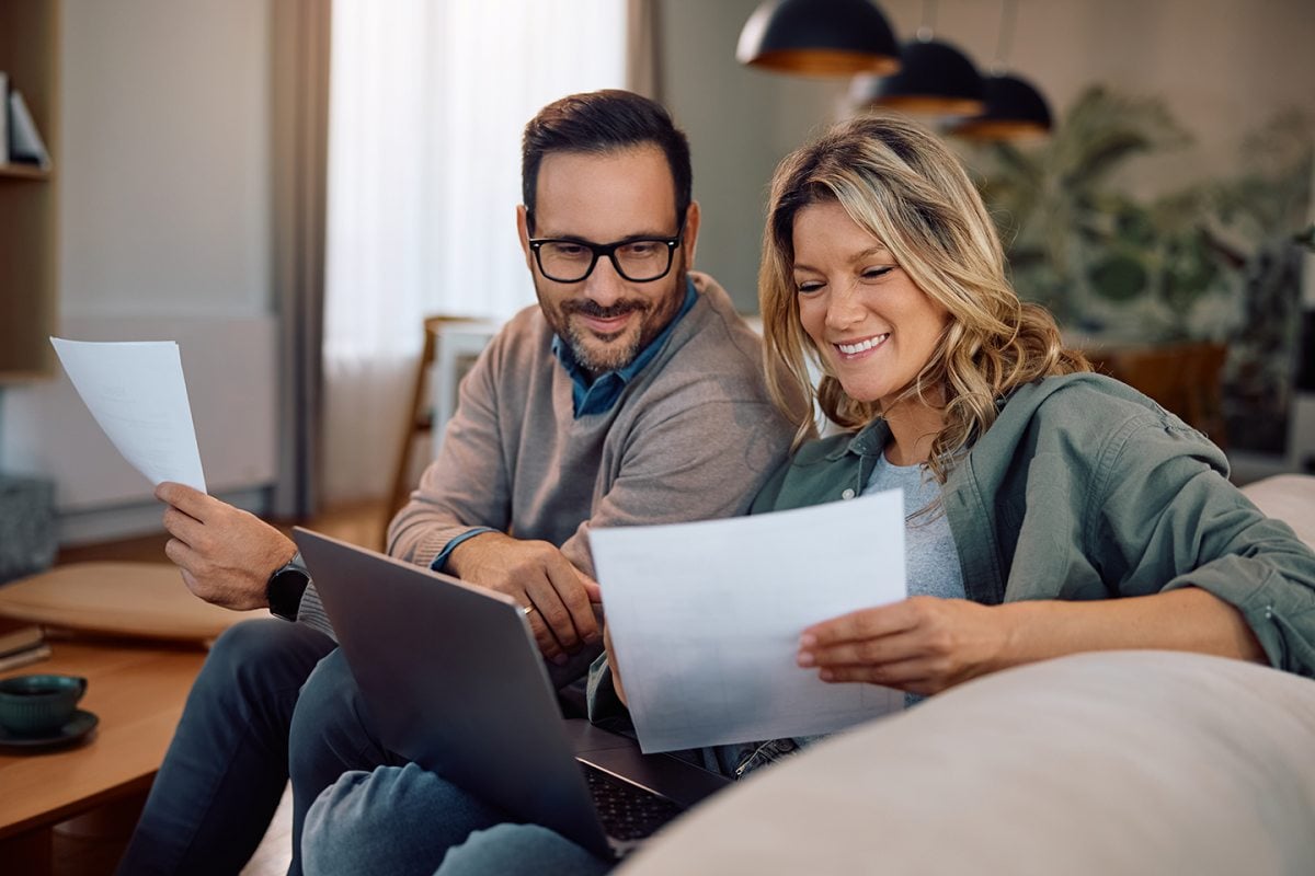 Couple reviewing short term loan documents together at home
