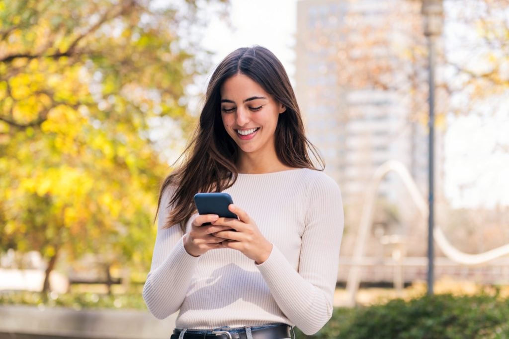 caucasian-woman-smiling-happy-using-mobile-phone (1)