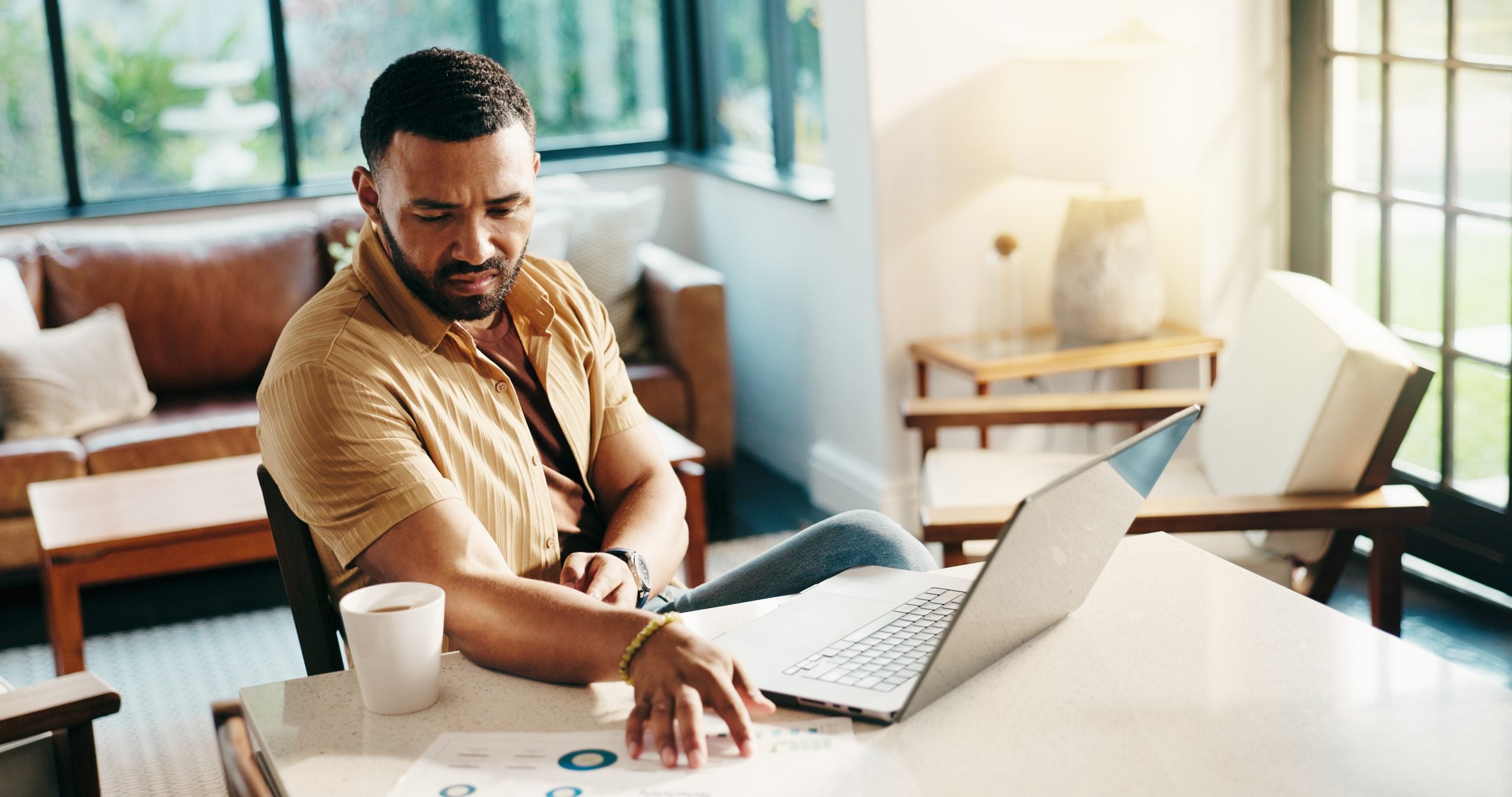 Alabama borrower planning loan repayment with paperwork at a home office