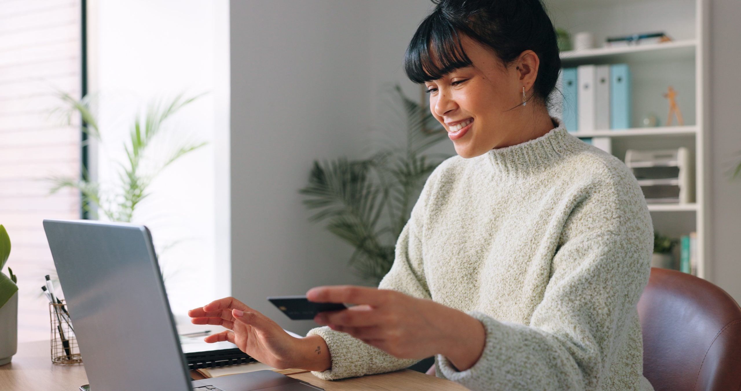 Person reviewing budget and online short-term loan options on a laptop